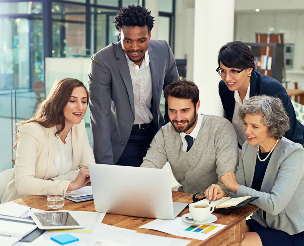 Advisors collaborating around a laptop